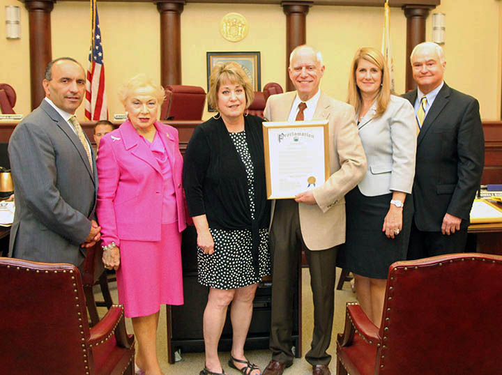 The Monmouth County Board of Chosen Freeholders presents proclamation to commemorate Dystonia Awareness to Len and Janice Nachbar of Freehold with the hope to raise public awareness of this debilitating disease that their daughter Joanna is living with at their regular public meeting on June 11 in Freehold, NJ. Pictured left to right: Freeholder Thomas A. Arnone, Freeholder Lillian G. Burry, Janice and Len Nachbar, Freeholder Deputy Director Serena DiMaso and Freeholder John P. Curley.